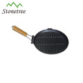 round vegetable oil cast iron skillet with wooden handle